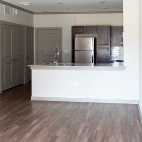 living room with wood floors, comfortable seating and doors that lead to a patio living room with wood floors, comfortable seating and doors that lead to a patio