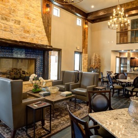 aerial image of resident kitchen with four tables witch chairs around them and a kitchen island with stove aerial image of resident kitchen with four tables witch chairs around them and a kitchen island with stove