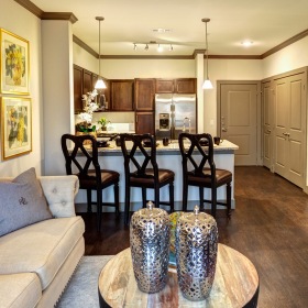 living area with wood flooring, plenty of light, next to kitchen area living area with wood flooring, plenty of light, next to kitchen area